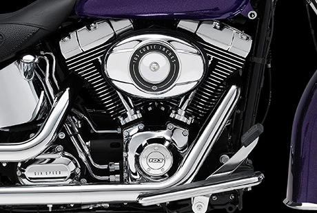 Softail Deluxe / Harley-Davidson Styling pur:    Genieen Sie den unverwechselbaren Look des Twin Cam 103 Motors, der an seiner Herkunft keine Zweifel aufkommen lsst. Er ist voll und ganz im echten Harley-Davidson Stil gestaltet  mit einer Liebe zum Detail, die Sie bei anderen Marken vergeblich suchen werden. Die schwarzen, pulverbeschichteten Zylinderkpfe und Zylinder bilden einen prgnanten Kontrast zu den polierten Khlrippenkanten und verchromten Ventildeckeln. Ein aus Metall gefertigtes Juwel: pur und vor Kraft strotzend. Von der klassischen Linie seiner Khlrippen bis hin zu den klaren Konturen seiner Gehuse und Deckel ist der Twin Cam 103 ein rckhaltloses Bekenntnis zu allem, was die Zufriedenheit des Fahrers ausmacht.
